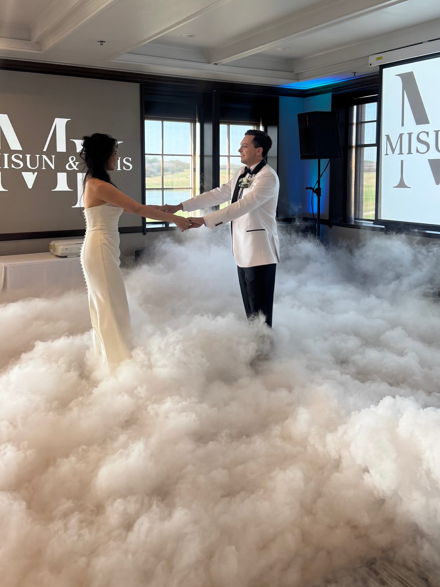 Couple sharing their first dance on a low-lying dry ice cloud at The Clubs of Stonebridge Ranch in McKinney