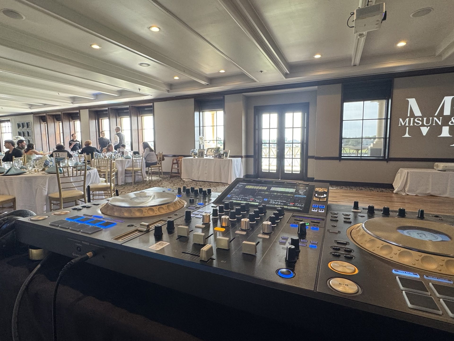 Pioneer XDJ-AZ at the DJ table facing a country club wedding reception room
