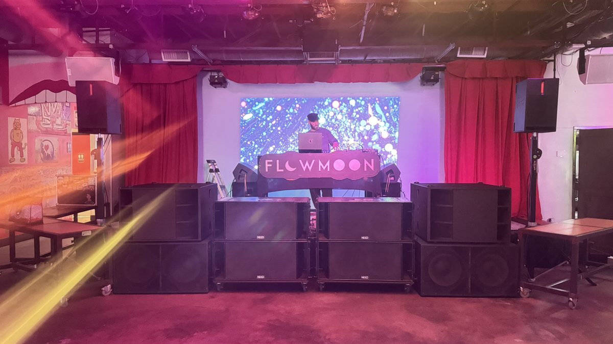 BassBoss subwoofers stacked at the edge of a dance floor at a Dallas party