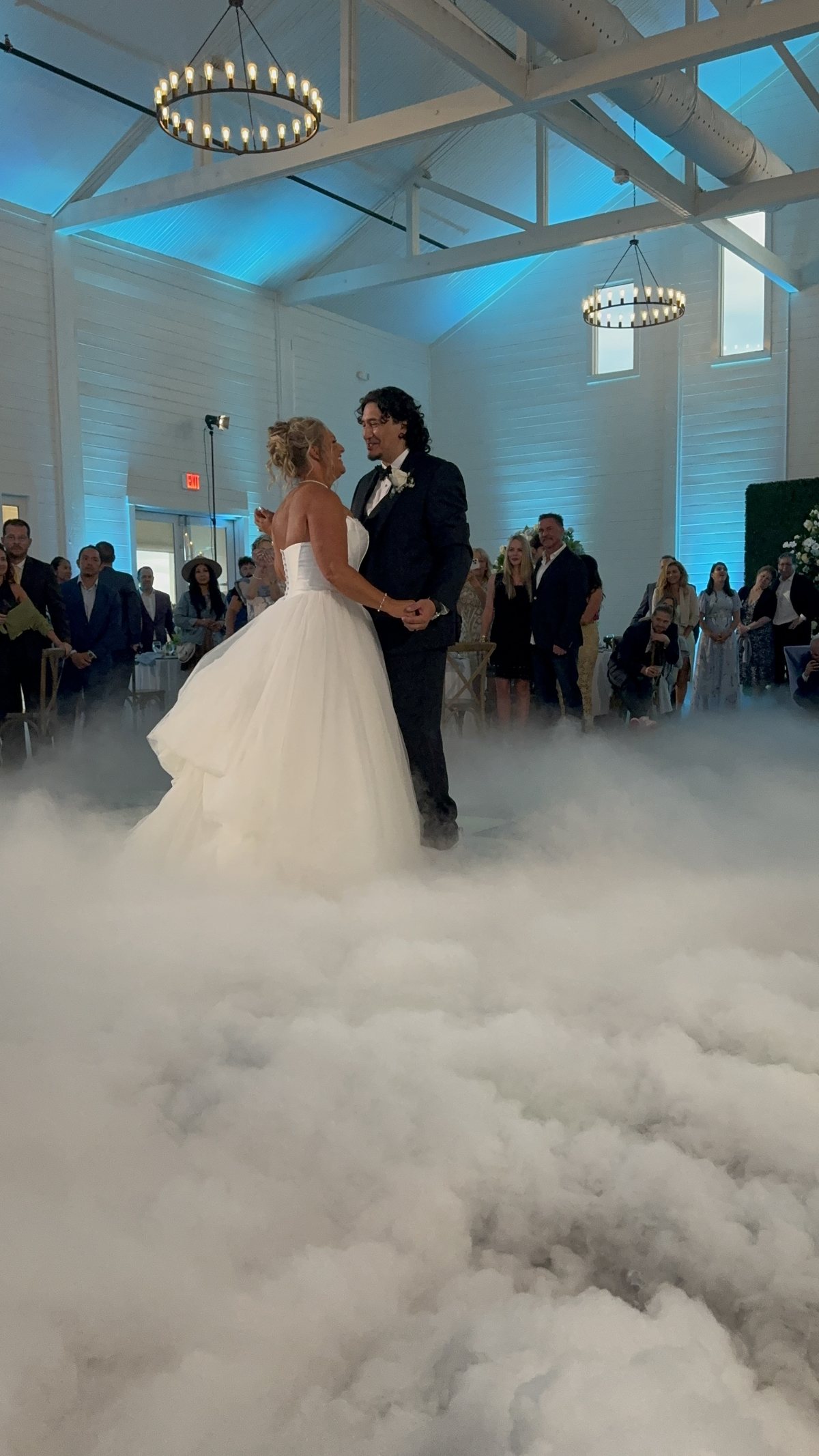 Dry ice clouds sitting flat on the dance floor around a couple during a first dance in Dallas
