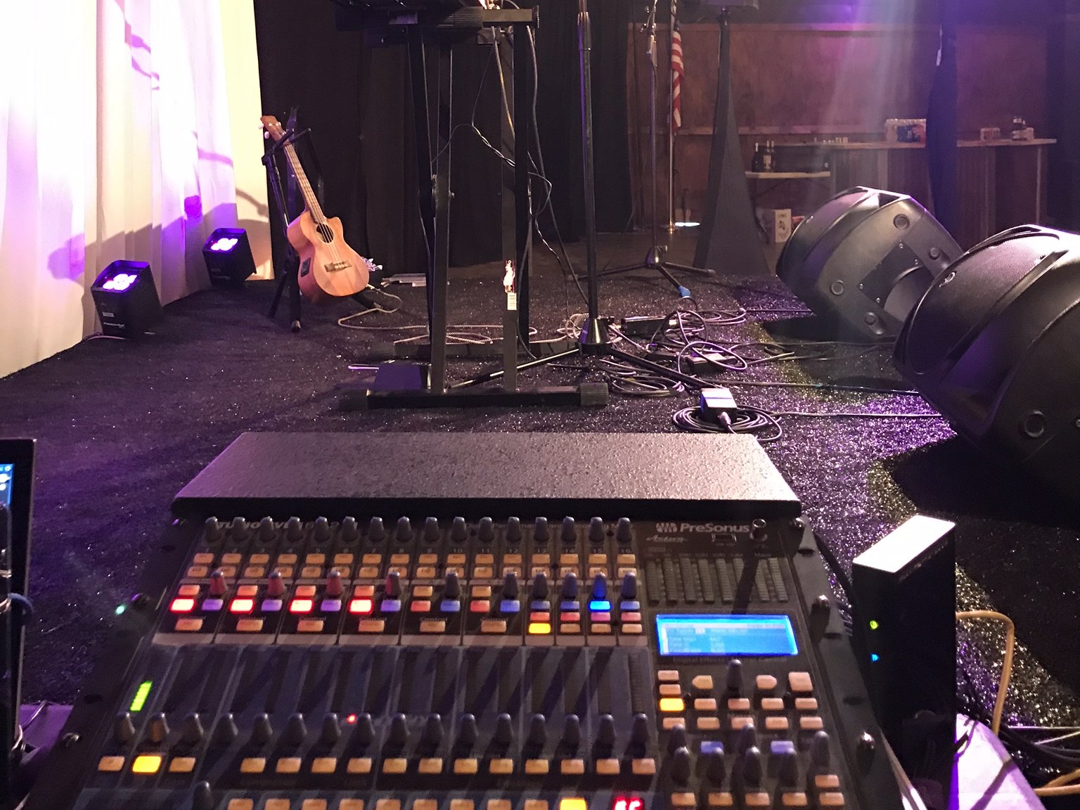 Our engineer at the front of house mixing console during a live band show in Fort Worth