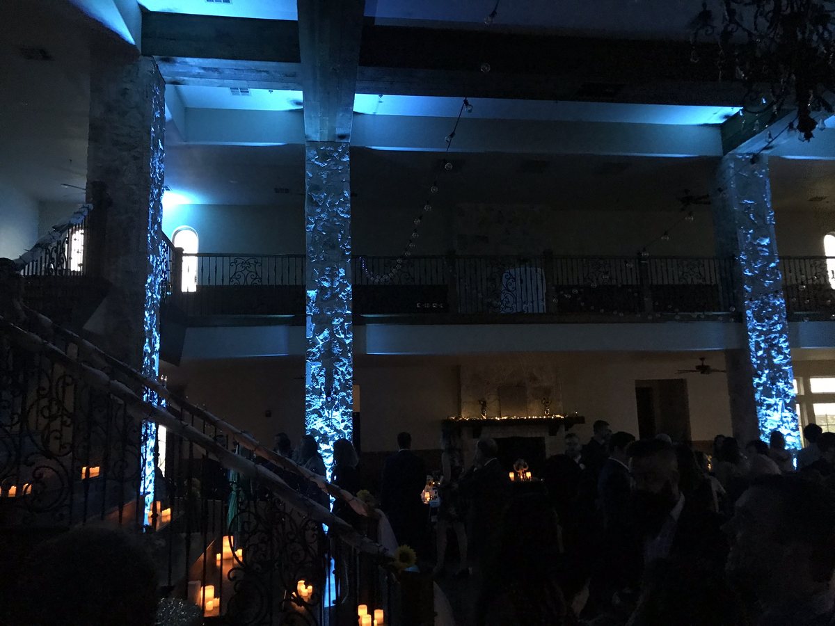 Uplighting washing the columns of a grand ballroom at a Plano event