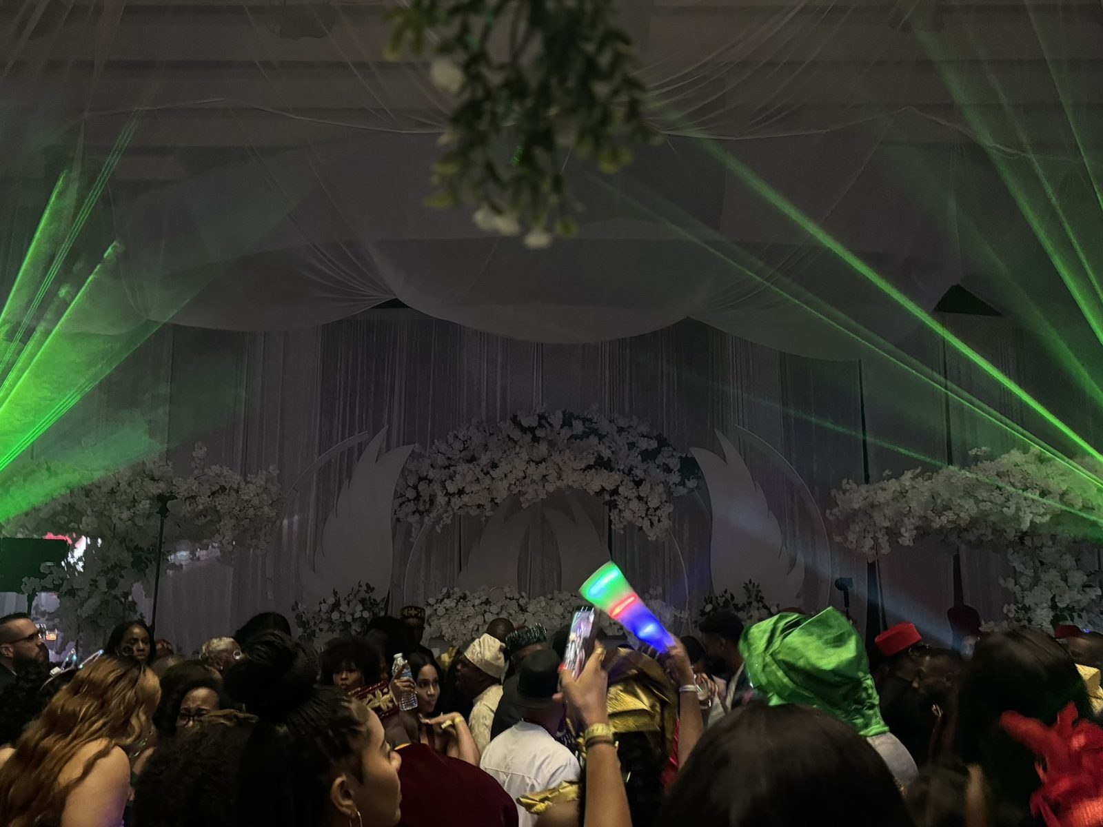 Aerial laser beams fanning out over a wedding dance floor at a Dallas-Fort Worth reception