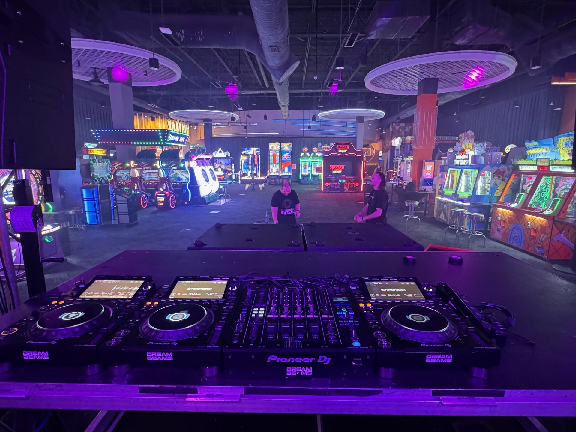 A Pioneer CDJ booth flanked by BassBoss DV12 arrays at a Dallas venue